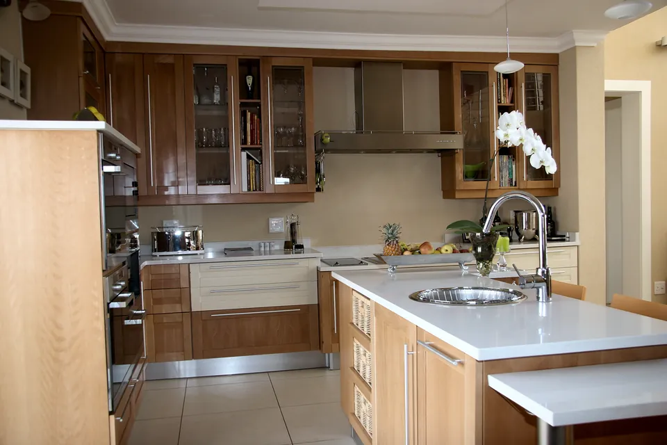 Island with a sink and a breakfast counter