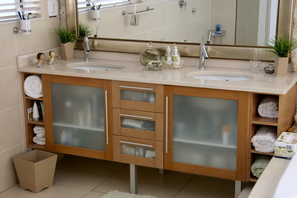 Double vanity in pink beech with frosted-glass doors and open towel shelves
