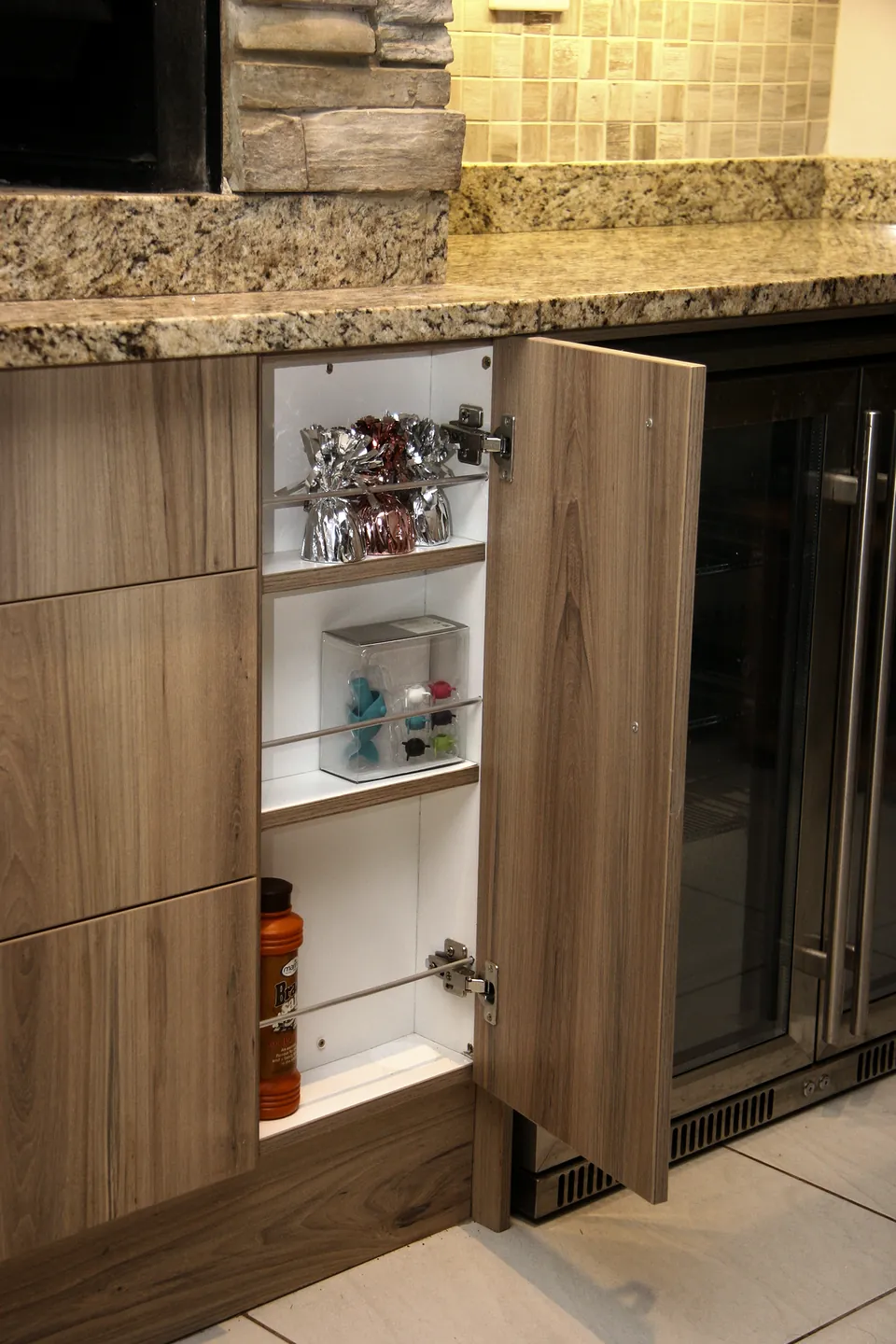Tall cupboard opened beside the drinks fridge