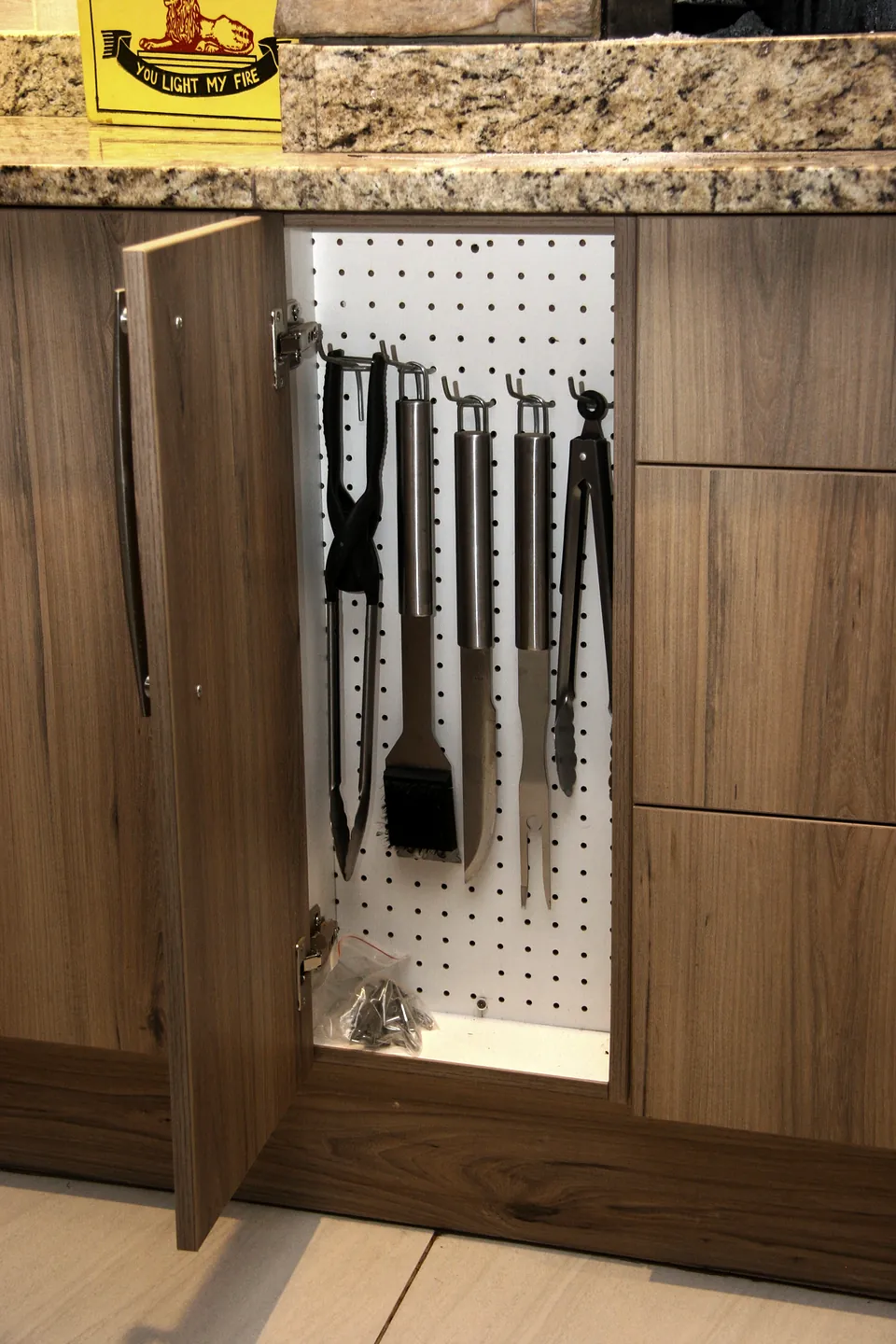 Braai tools hung behind a cupboard door