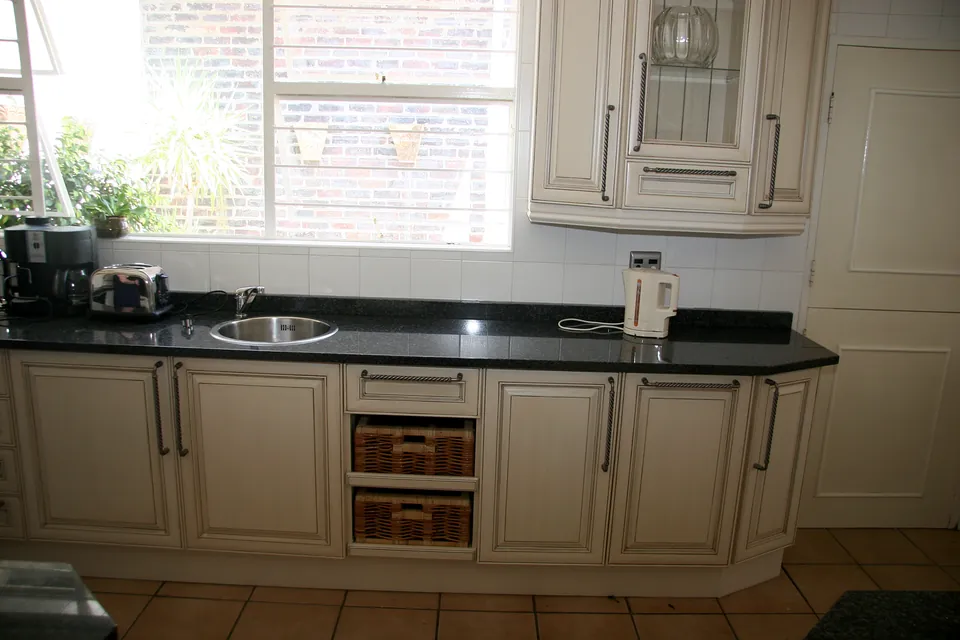 Sink run with wicker basket drawers under the window