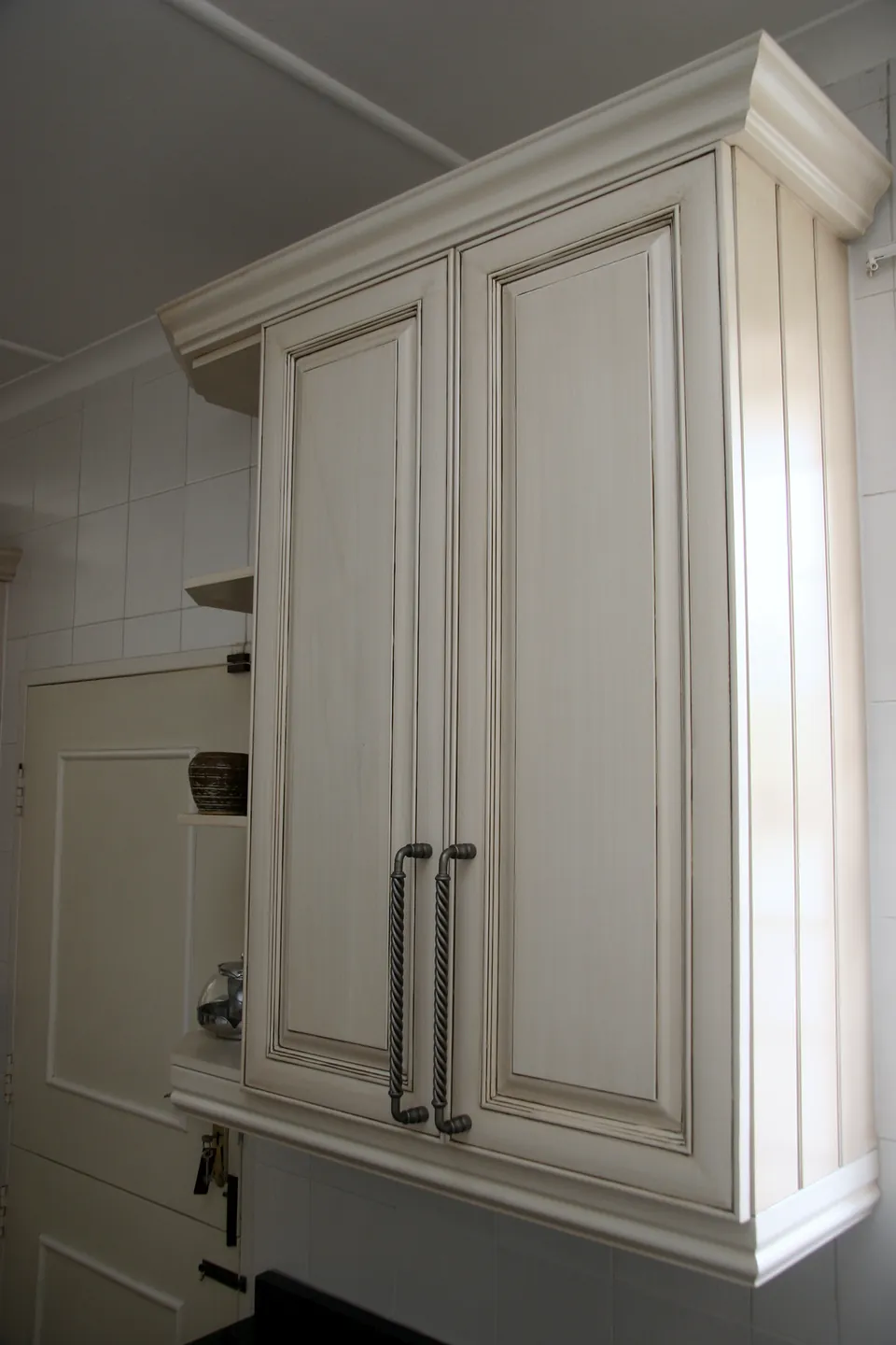 Tall painted cupboard with a glazed finish