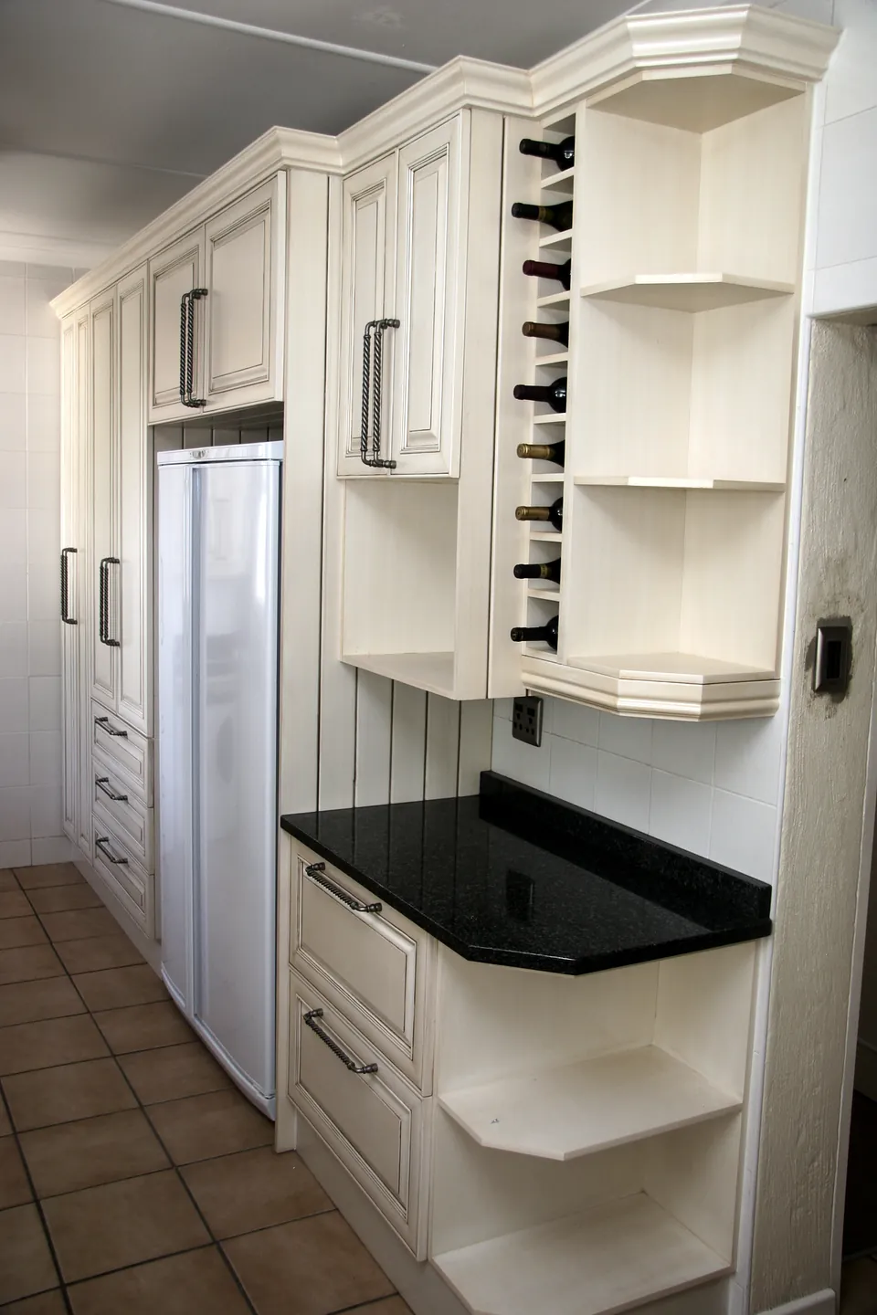 Wine rack and quarter-round shelves at the end of a run