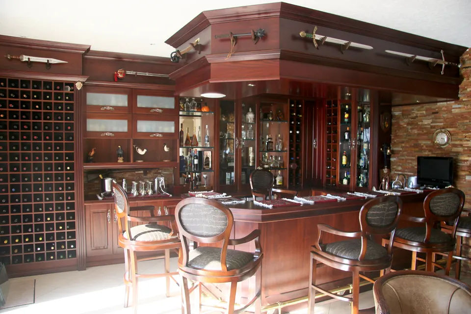 Home bar in solid African mahogany with a canopy, back bar and a wall of wine storage