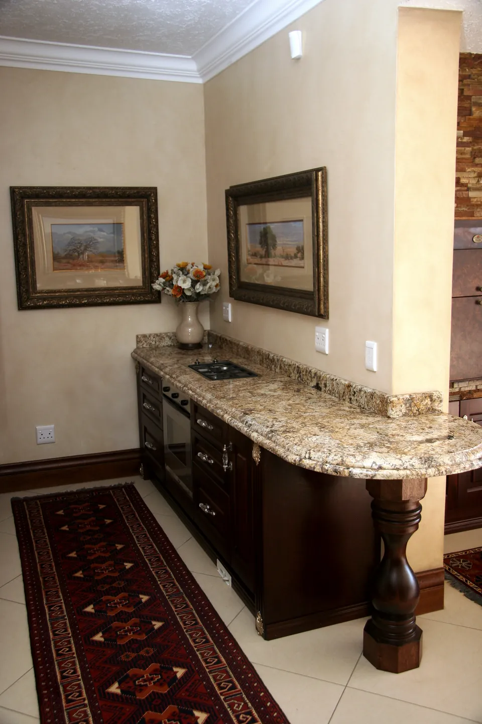 Indoor braai kitchen in mahogany with a granite top on a turned leg