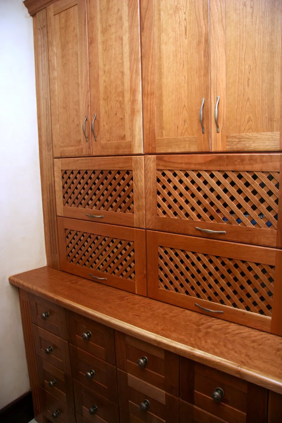 Cloakroom cabinetry in solid cherry with fretwork panels