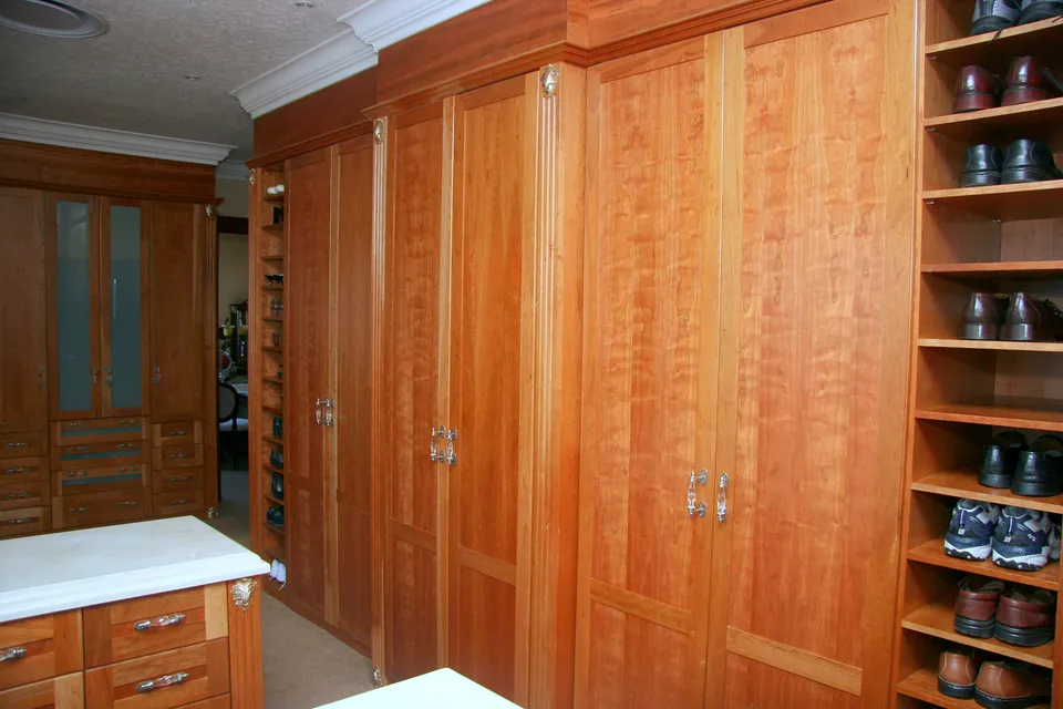 Main bedroom dressing area in cherry with full-height shoe shelving