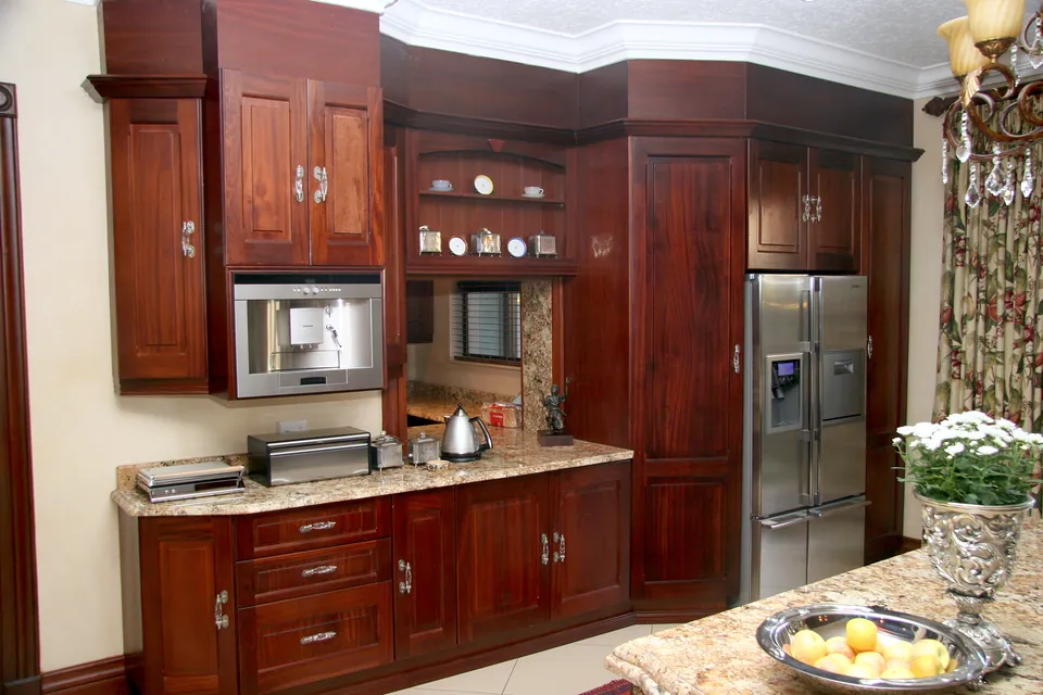 Built-in coffee machine and fridge housing in solid mahogany