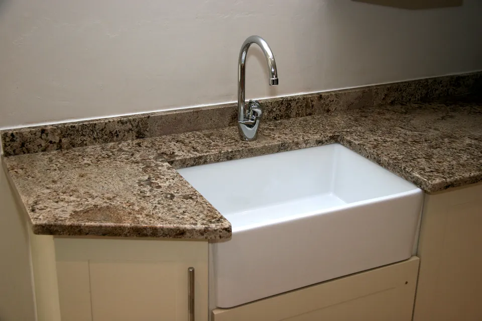Farmhouse sink set into a granite top
