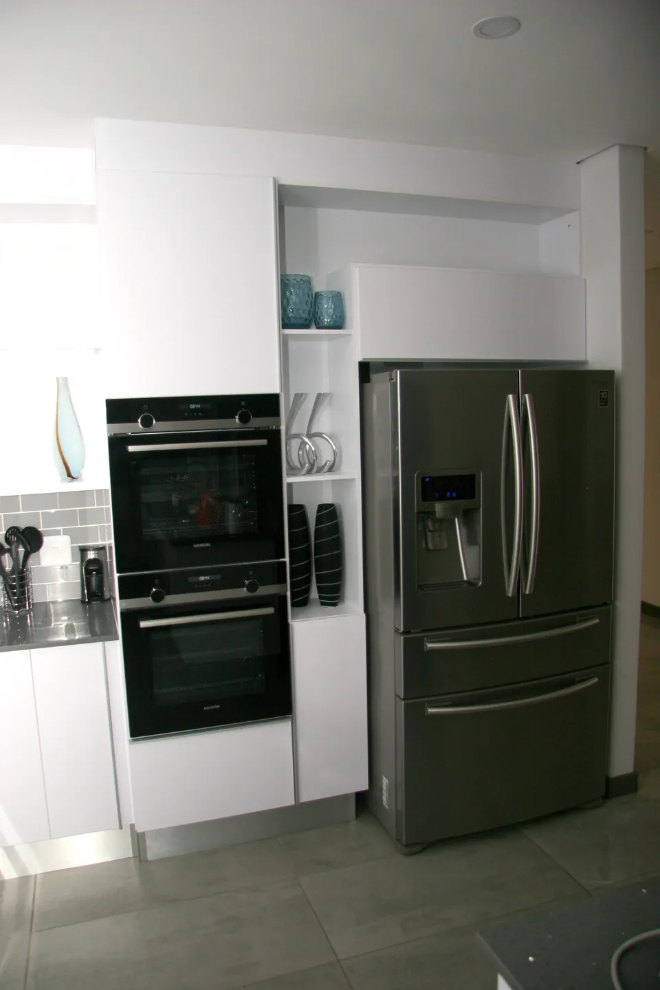 Double oven tower beside the fridge housing