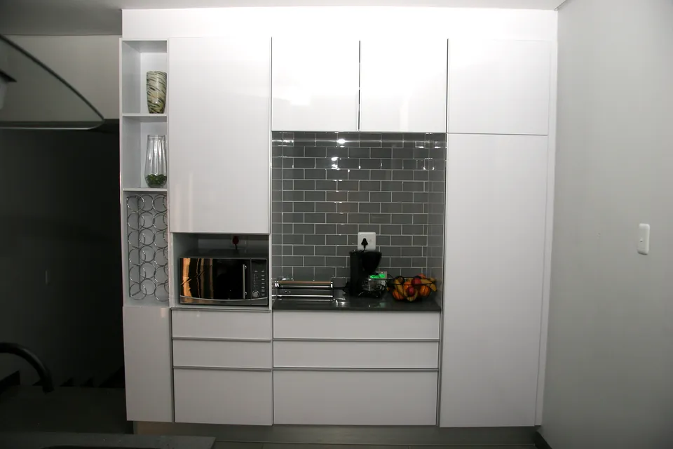 Appliance wall with open shelves and a coffee niche