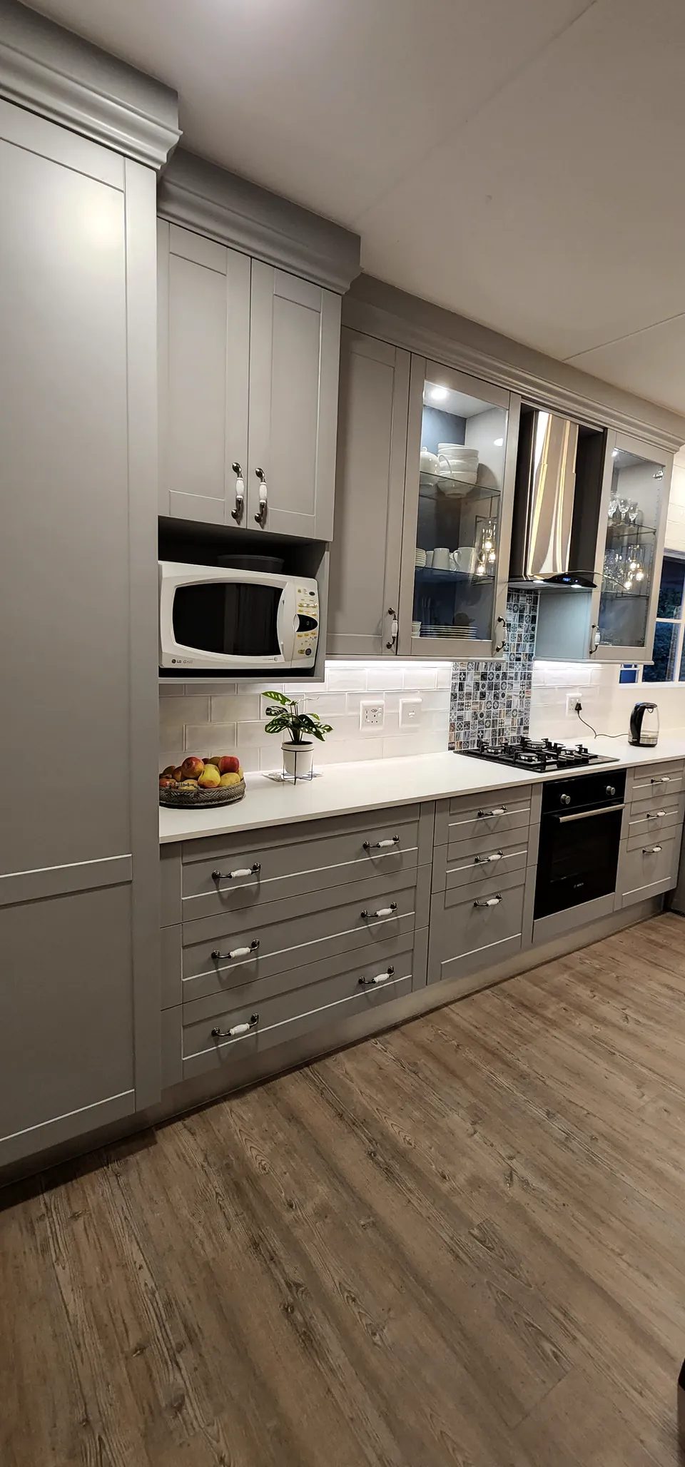 Tall unit with a microwave housing