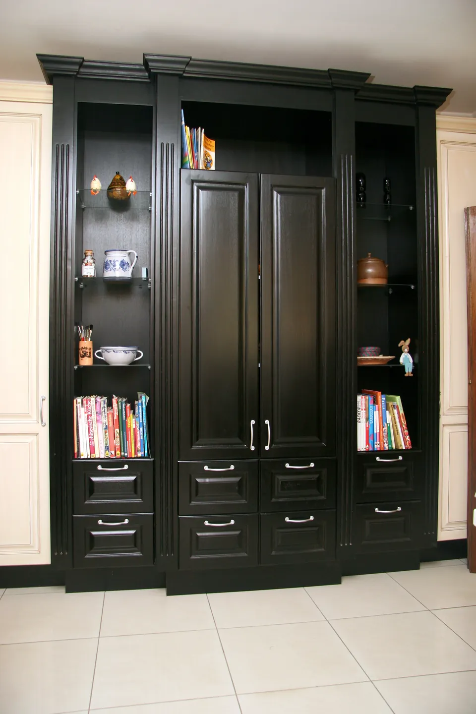 Black dresser with open shelves and a cookbook niche
